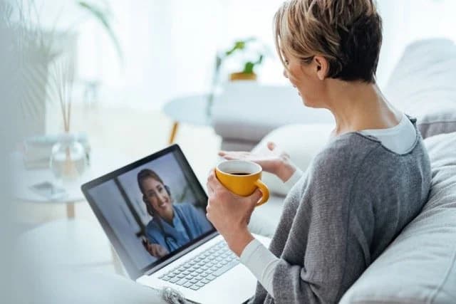 Woman having a video call with her doctor on a laptop